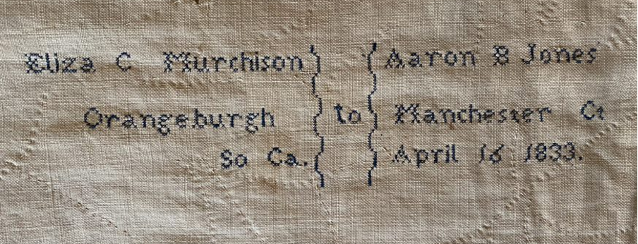 Cross-stitched embroidery on the reverse of the quilt by Eliza C. Murchison,