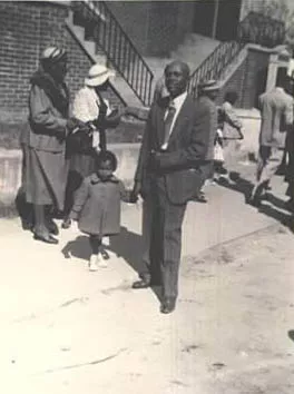 Deacon Lucius W. Dakers and daughter, Beryl, standing outside First Nazareth Baptist Church, circa 1953
