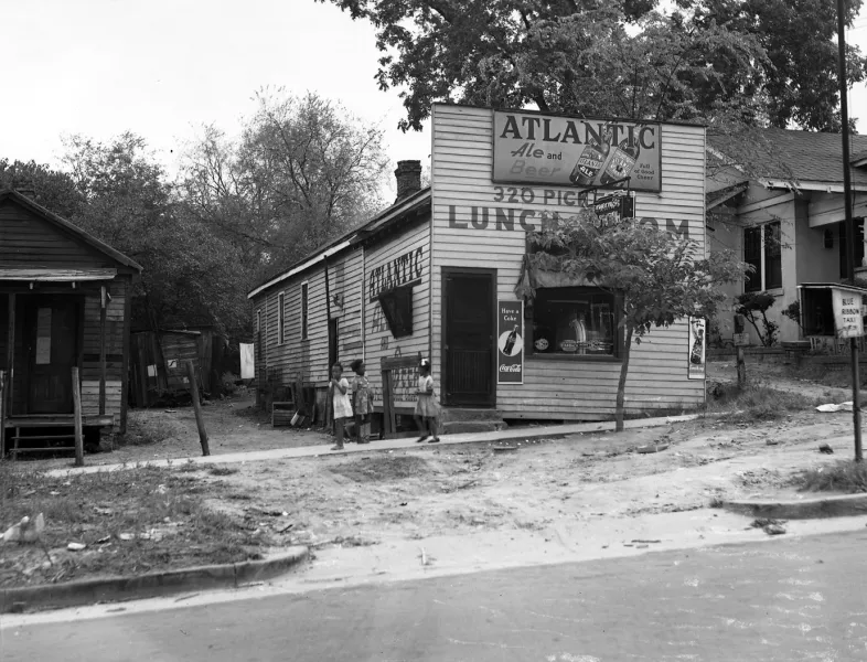 Black youth gather in front of a lunch room that formerly stood at 320 Pickens Street.
