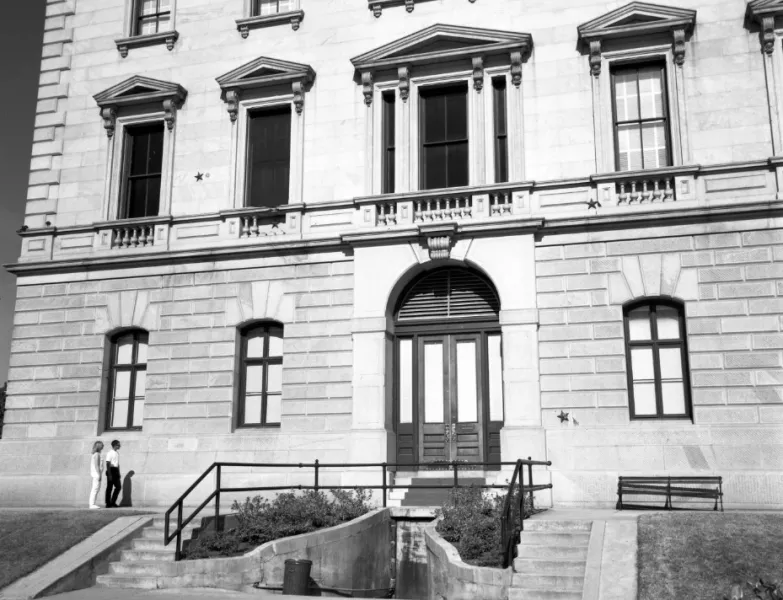 Western elevation of the State House, September 1968. Russell Maxey photographed a couple reading the inscription of the bronze stars.