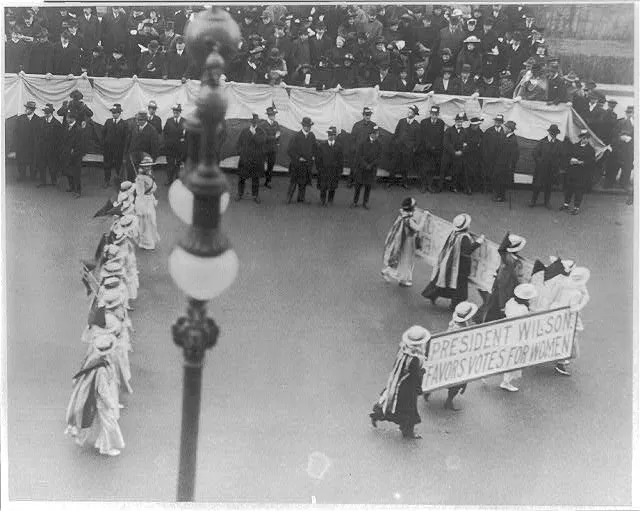 Suffragettes parading with banner “Wilson favors votes for women”. N.Y.C., 1916