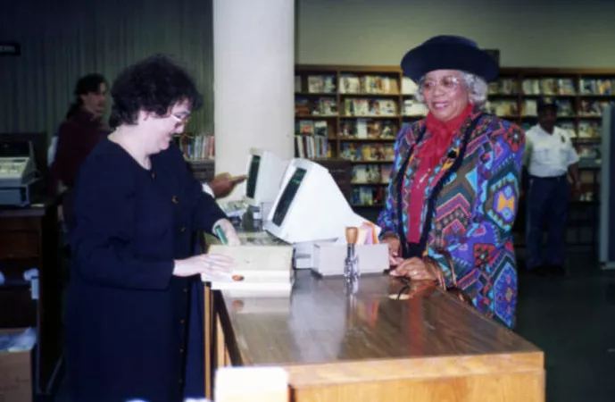 Martha Cunningham Monteith checks out the last book at Richland Library’s original building on Sumter Street, 1990.